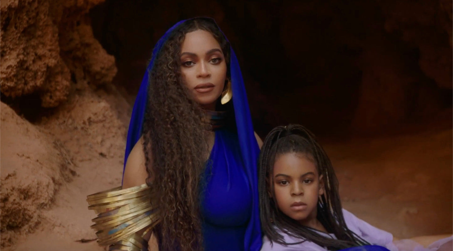 Beyonce wearing the ROKUS London Demi Fula gold hook earrings and seating with Blue Ivy in the Bigger video.